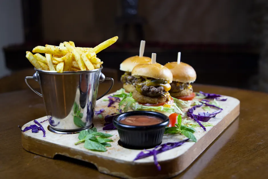 Delicious gourmet mini burgers with fries served in Amman, Jordan. Perfect fast food presentation.
